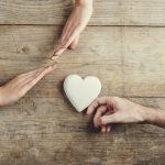 Man offering a heart to a woman.